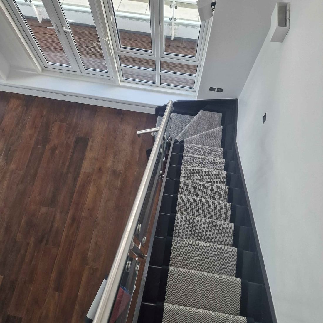 Black faux sisal runner on a modern penthouse staircase