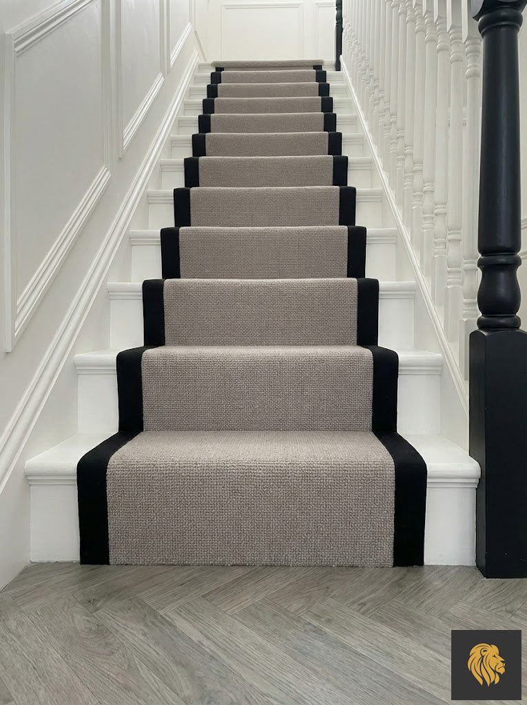 Grey wool stair runner with a black border, black staircase spindles