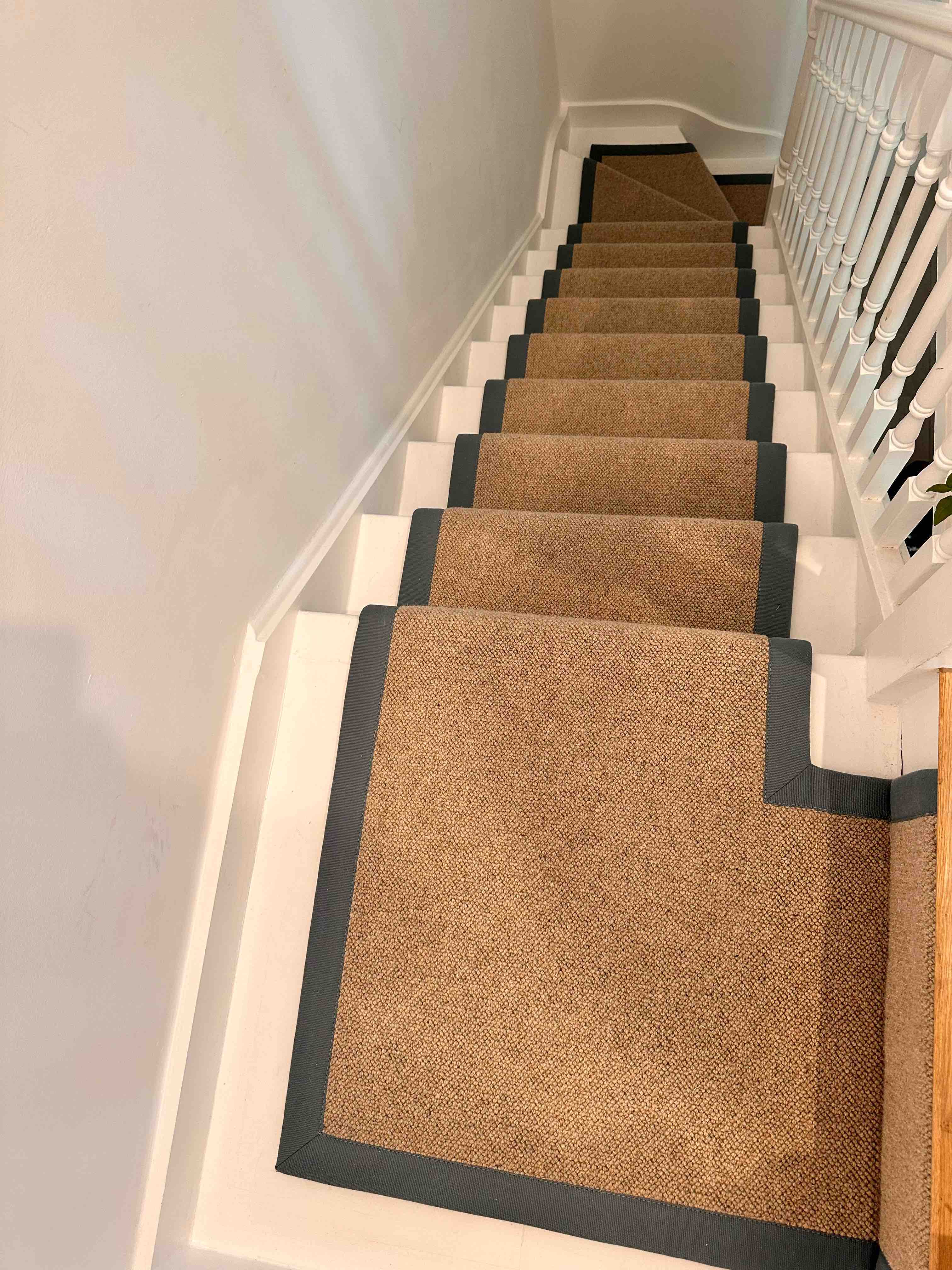 Natural bouclé stair runner with a black cotton border