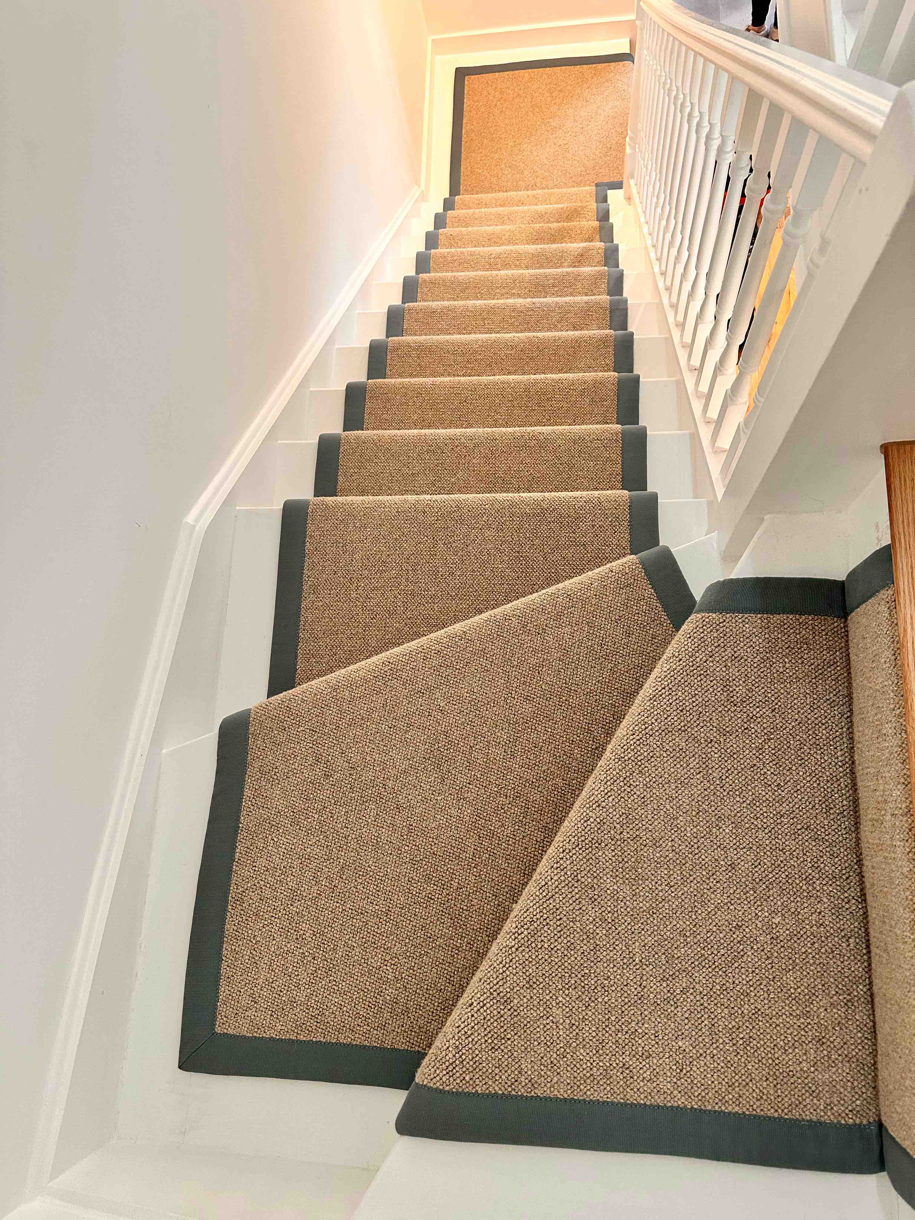 Natural bouclé stair runner with a black cotton border